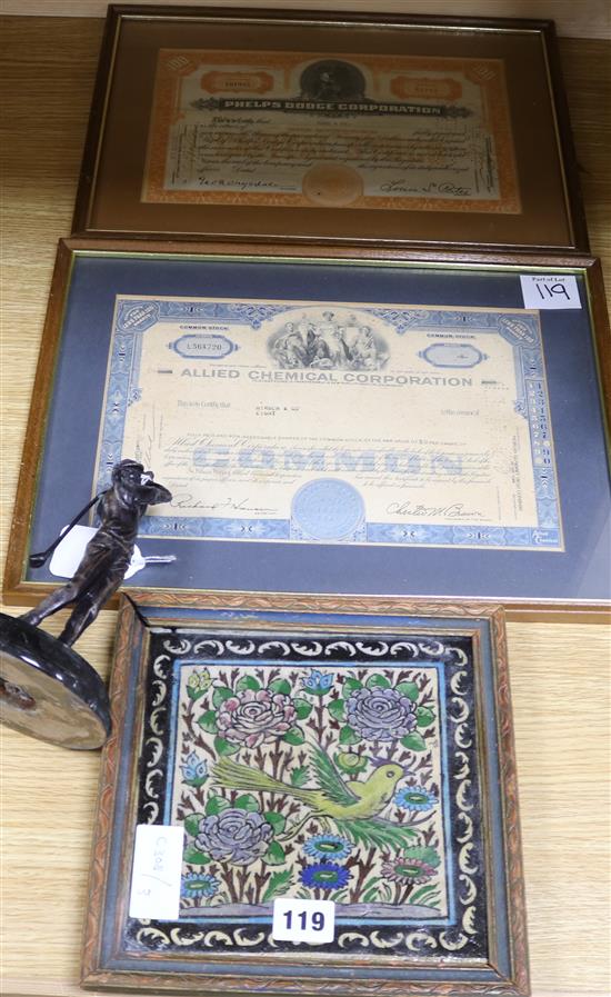 A bronze model of a golfer and two certificates